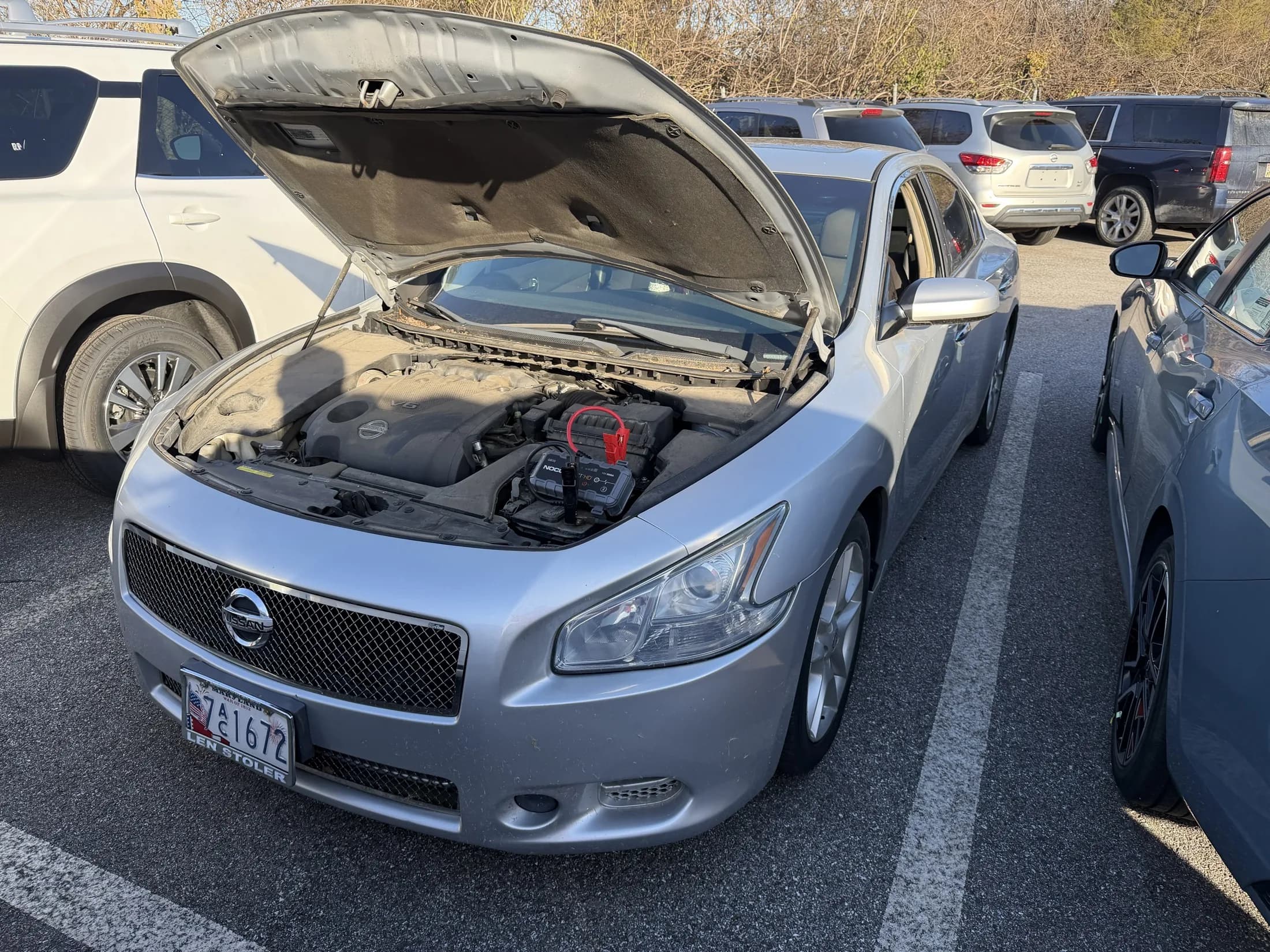 Roadside jump start service with a vehicle hood open